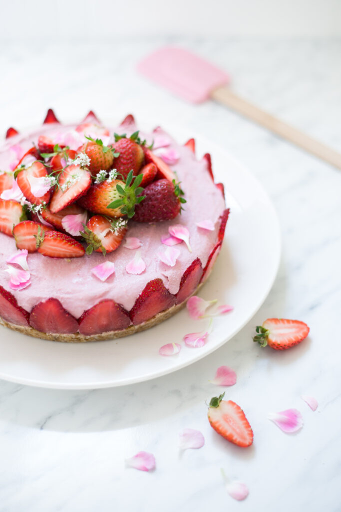 Vegan strawberry cheesecake with fresh ingredients, coconut oil, cashew nuts and strawberries